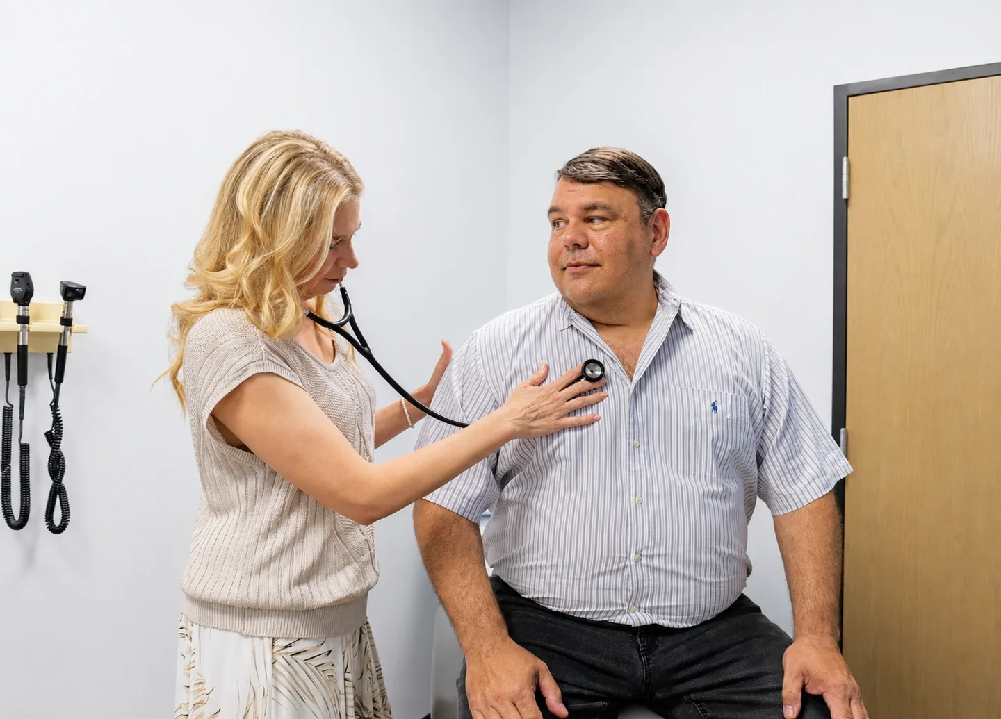 Dr. Eva Mackey Meyrat, MD, listening to a patient's heart during an exam at Gem MD in Rockwall, Texas