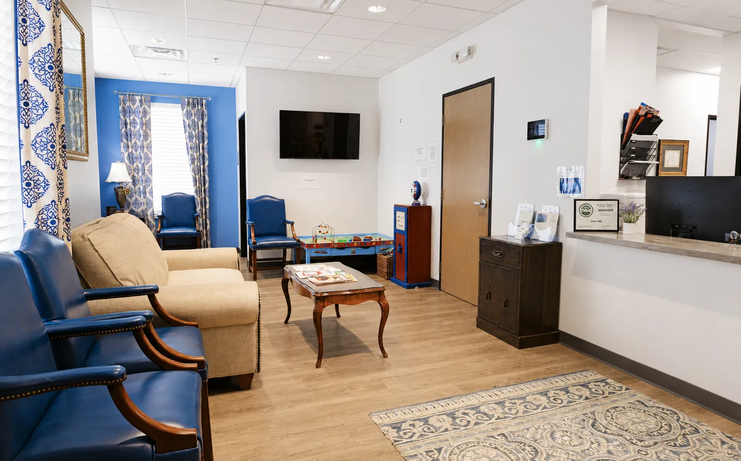 The Gem MD waiting room and front desk, with a children's play table