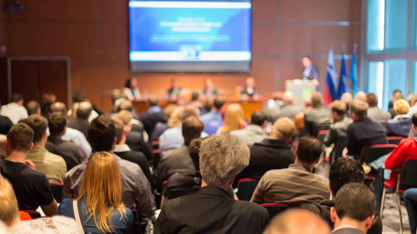 Audience listening to a panel discussion at an industry conference