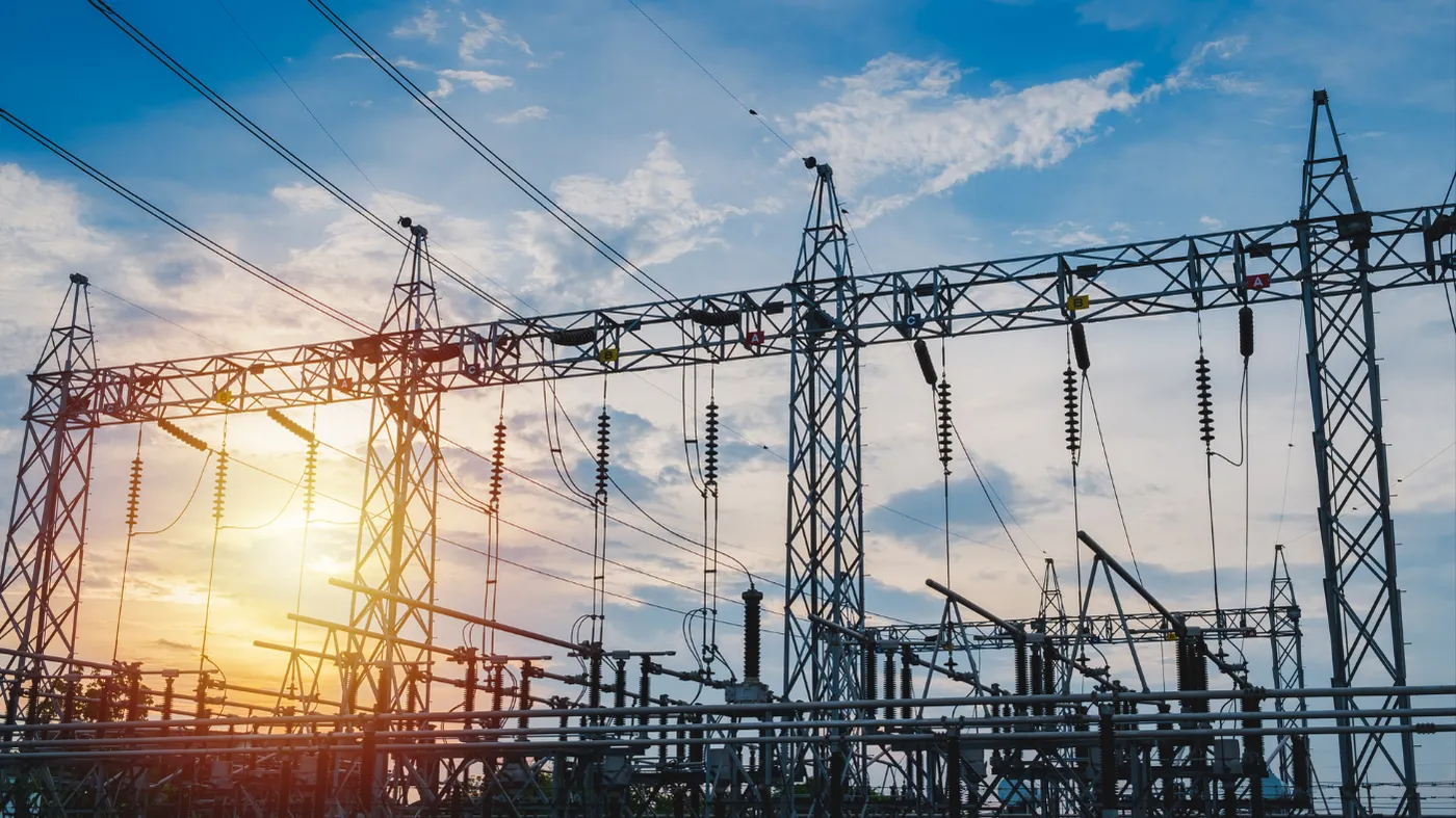 Electrical substation with transmission towers at sunset